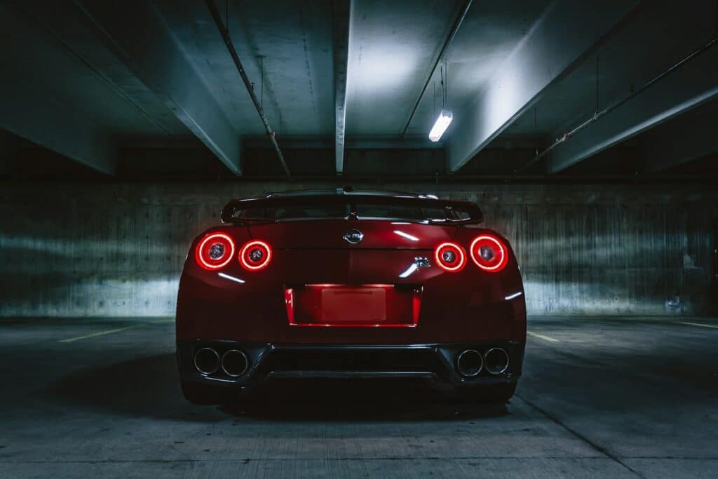 red sports car on concrete flooring